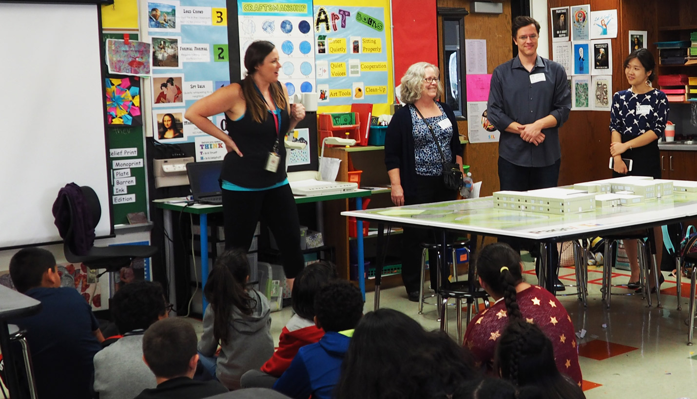 Volunteers including Pagers explain to Blackshear Elementary students how the design exercise of the school's outdoor performance venue will work. - Page