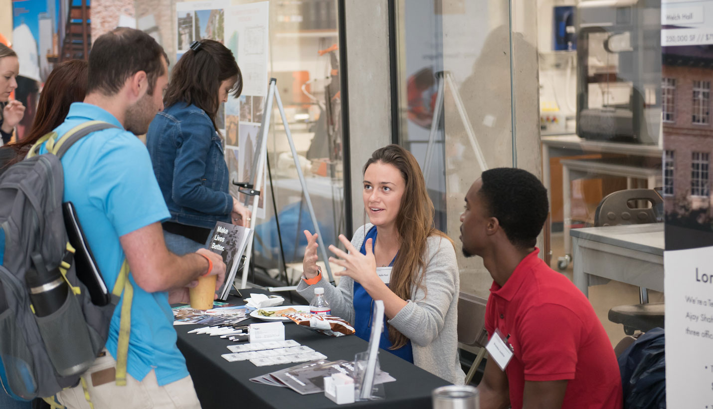 Page interns Hallie Pace and Brandon Justice talk to engineering students. - 