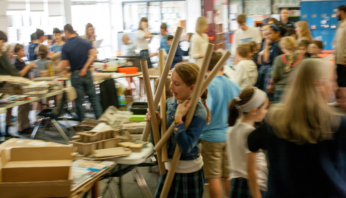 A Trinity Episcopal student gathers materials for her team's STEAM design exercise. - Page